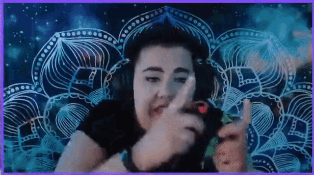 a woman wearing headphones is playing a game on her phone .