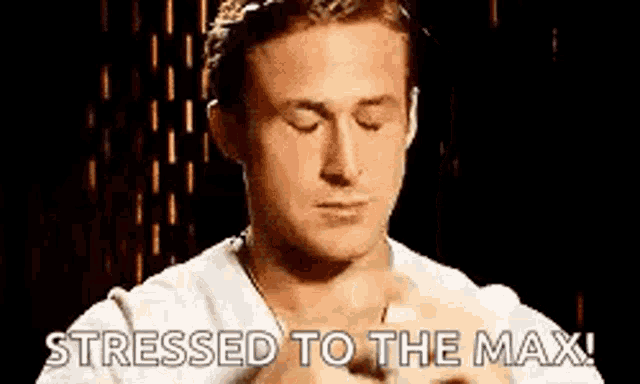 a man is stressed to the max with his eyes closed and his hands together .