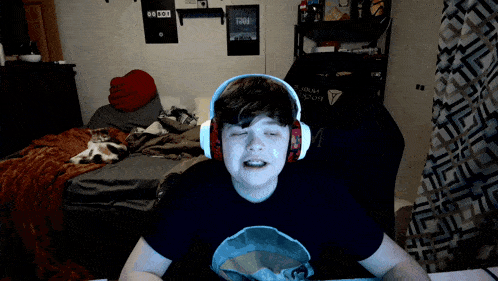 a boy wearing headphones in a bedroom with a cat and a sign that says ' 00 00 ' on it