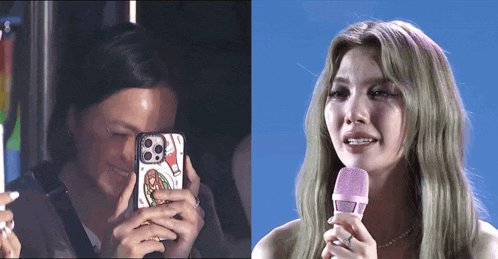 a woman is taking a picture of herself and a woman is crying while holding a pink microphone .
