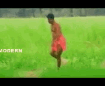 a man in a red skirt is walking through a grassy field