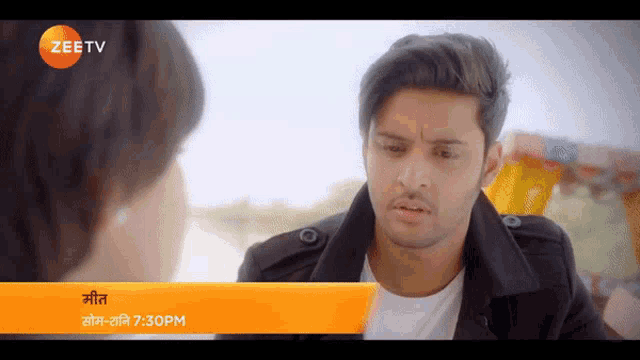 a man is talking to another man on a screen that says zeetv