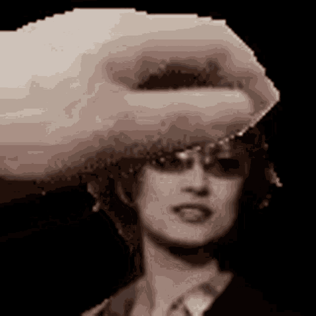 a pixelated image of a woman 's face with a hand holding her head .