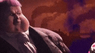 a man in a suit and tie is looking at a pink balloon .