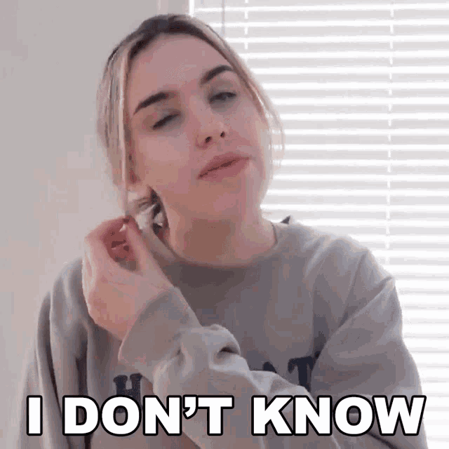 a woman wearing a sweater that says i don 't know on it