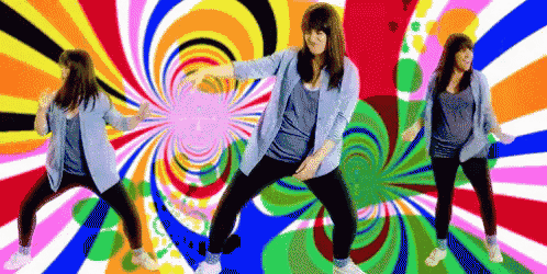 a woman is dancing in front of a colorful swirl background