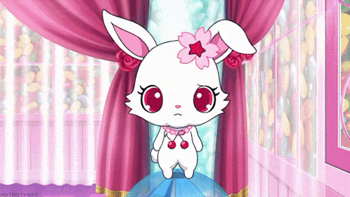 a white rabbit with a pink flower on its head stands in front of a pink curtain