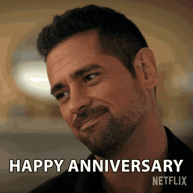 a man with a beard is smiling with the words happy anniversary written below him