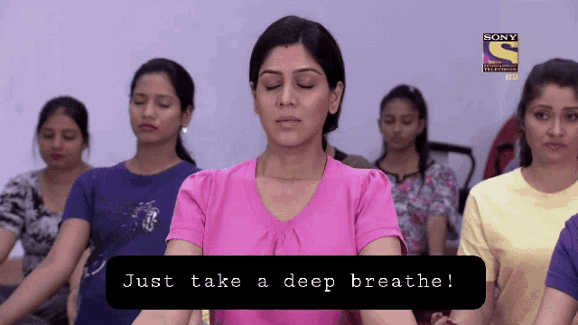a group of women are meditating in front of a sony logo