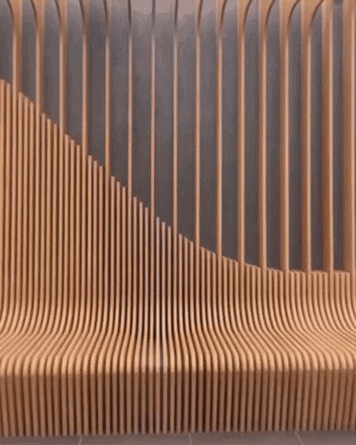 a row of wooden slats against a gray wall