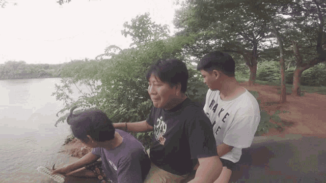 a man wearing a black shirt that says make life