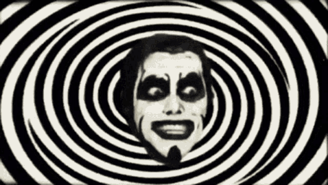 a man 's face is surrounded by black and white hypnotic spirals