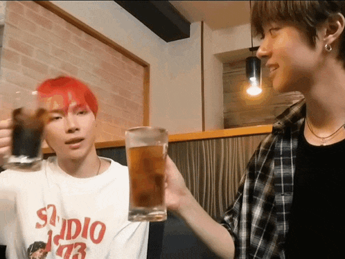 a man with red hair is wearing a white shirt that says studio 77