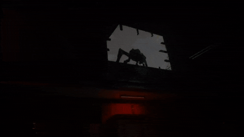 a dark room with red lights and a sign that says ' emergency exit ' on it