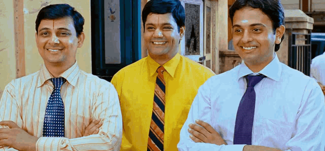 three men are posing for a picture and one is wearing a yellow shirt