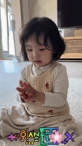 a little girl is sitting on the floor with the letters x and y on the bottom right