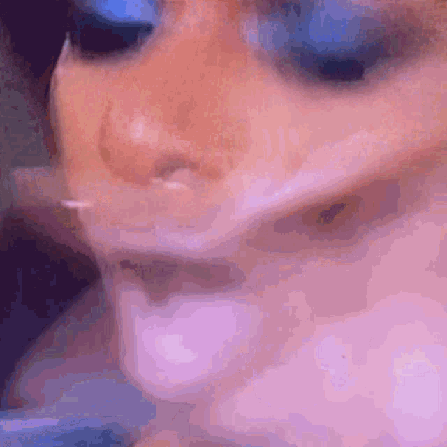 a close up of a person smoking a cigarette