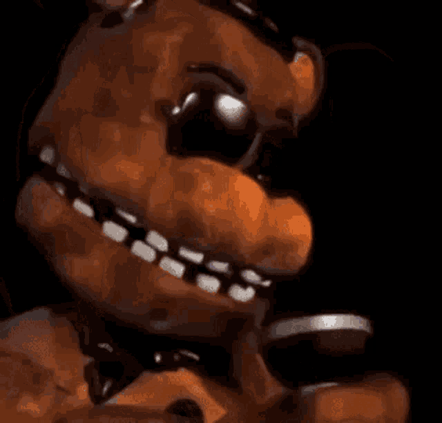 a close up of a teddy bear wearing sunglasses and a microphone .