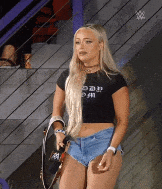 a woman in a black shirt that says daddy m