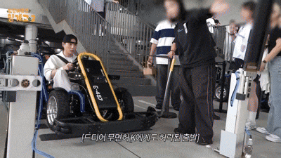 a man is sitting in a go kart with the number e457 on the back