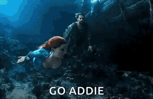 a man and a woman are swimming in the ocean and the words go addie are visible