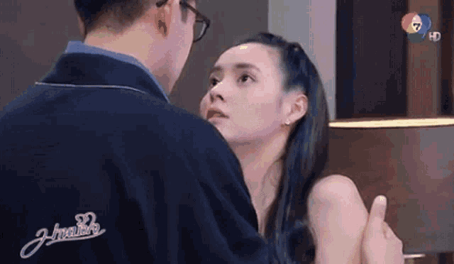 a man and a woman are standing next to each other in a room .