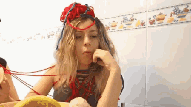 a woman wearing a red headband is peeling a banana