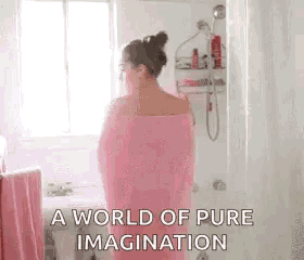 a woman wrapped in a pink towel is standing in a shower .