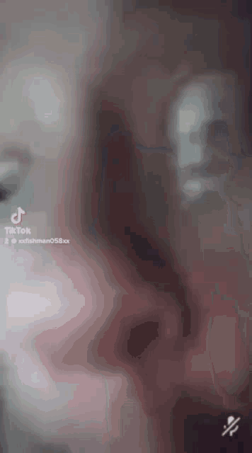 a blurred image of a person 's face with a tiktok watermark