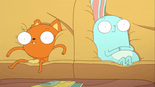a cat and a rabbit are sitting on a couch together