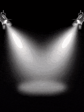 a pair of spotlights are shining on a black background