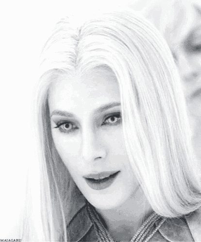 a black and white photo of a woman with long white hair and the name maigaru on the bottom