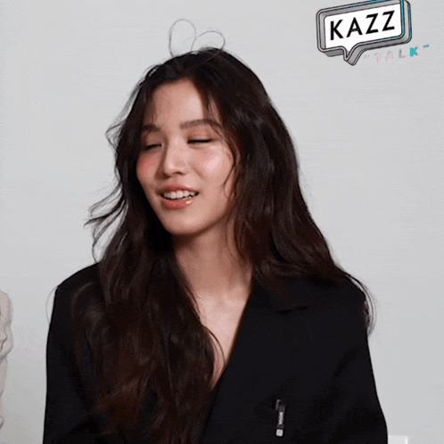 a woman in a black jacket with a speech bubble that says kazz