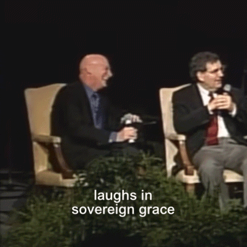 two men are laughing in front of a sign that says sovereign grace
