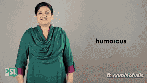 a woman in a green shirt is smiling and says humorous in sign language