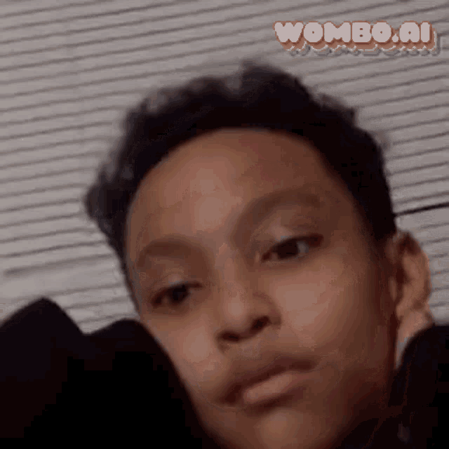 a close up of a young boy 's face with the words wombo.ai written on the bottom