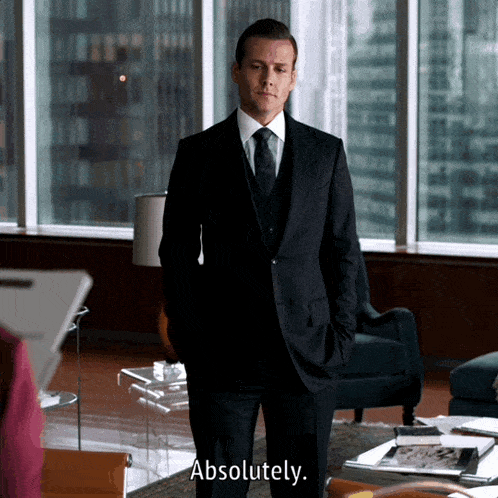 a man in a suit says absolutely in front of a window