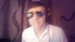 a blurry picture of a person wearing sunglasses and headphones