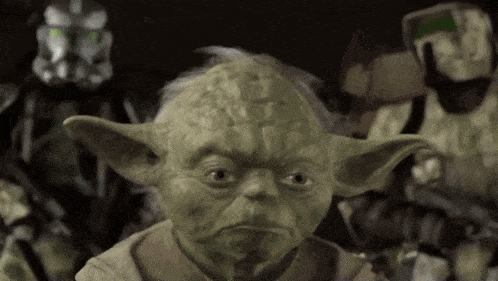 a close up of yoda 's face in front of a group of stormtroopers