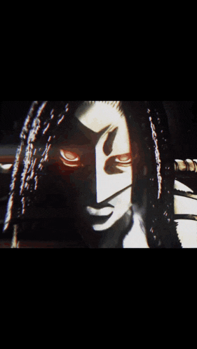 a close up of a woman 's face with dreadlocks and red eyes