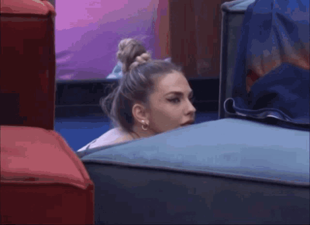 a woman in a bun is sitting on a couch