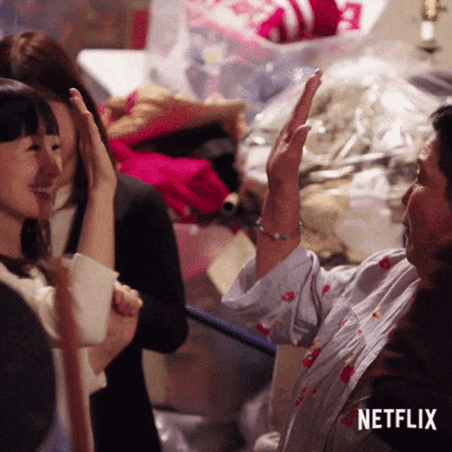 a woman giving a high five with a netflix logo in the corner