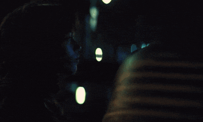 a blurry photo of a person 's face with a green light behind them