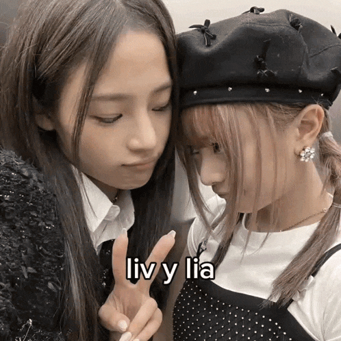 two girls are standing next to each other with the words liv y lia written on the bottom