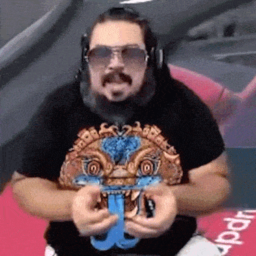 a man with a beard and sunglasses is wearing a black shirt with a tiger on it
