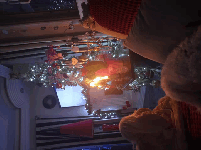 a christmas tree in a living room with a projector screen