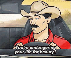 a man in a cowboy hat is driving a car and says " you 're endangering your life for beauty ? "