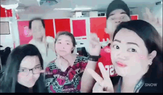 a group of people are posing for a picture together .