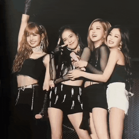 a group of young women are posing for a picture on a stage .