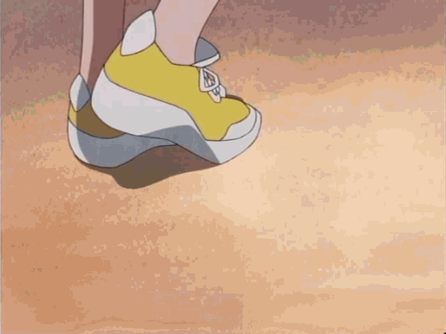 a close up of a person 's feet wearing yellow shoes